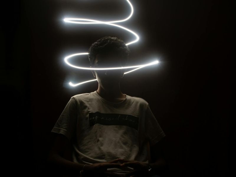 Wide view of a dark yoga studio with neon raspberry highlights.